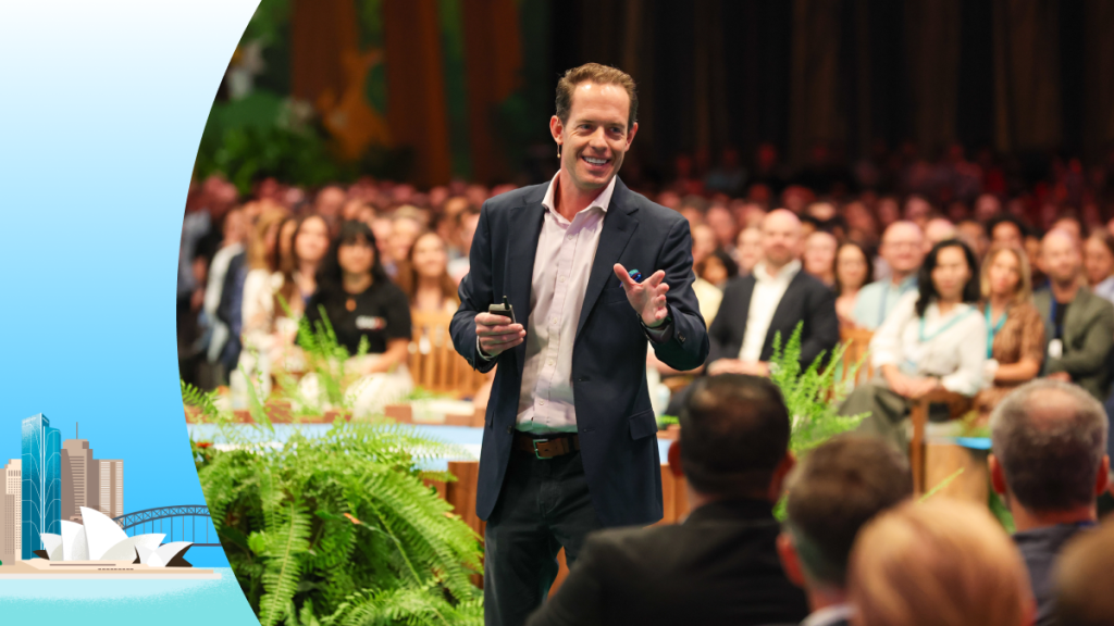 Image of a man presenting on stage at a conference